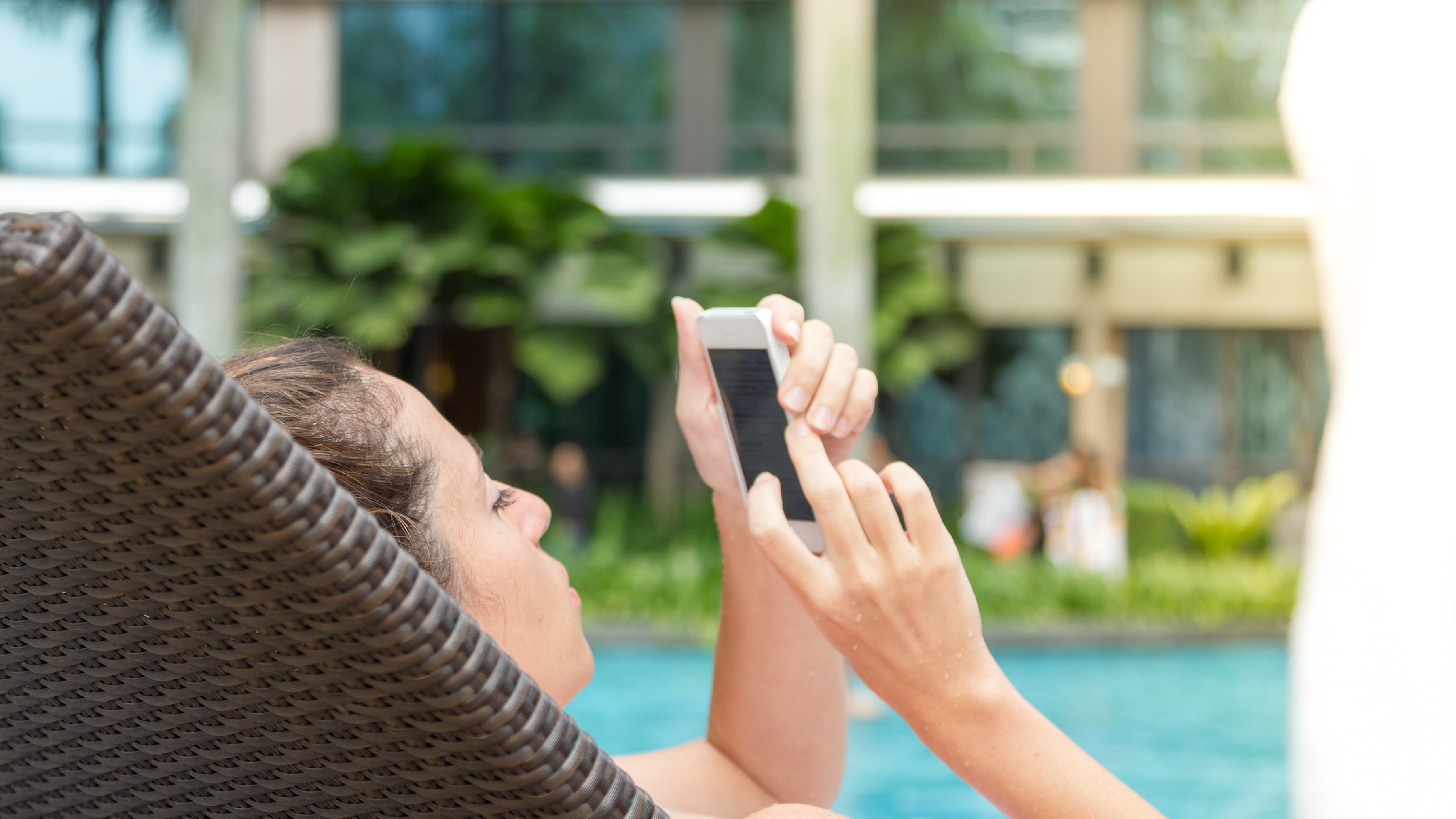 Woman on a Mobile Phone Travel website on a mobile device